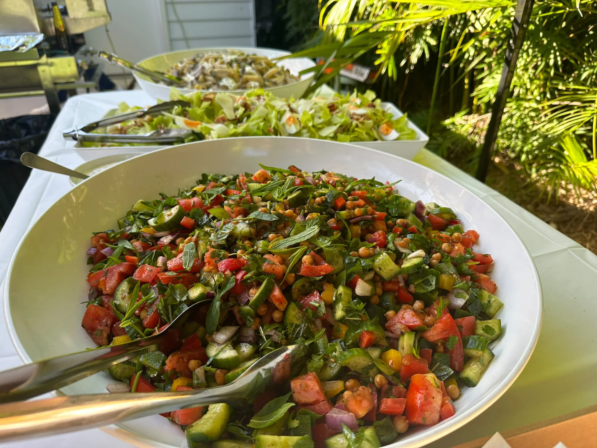 Bowls of fresh salads on a table outdoors