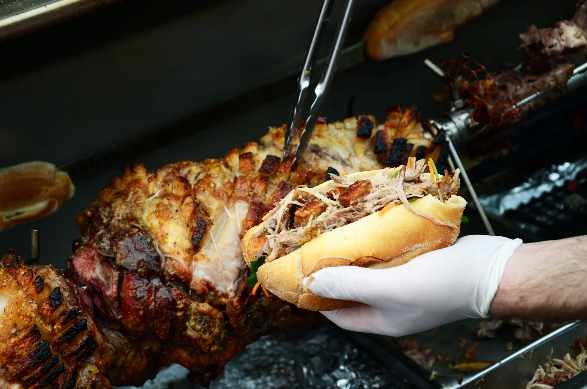 A pulled pork and crackling roll served straight from the spit
